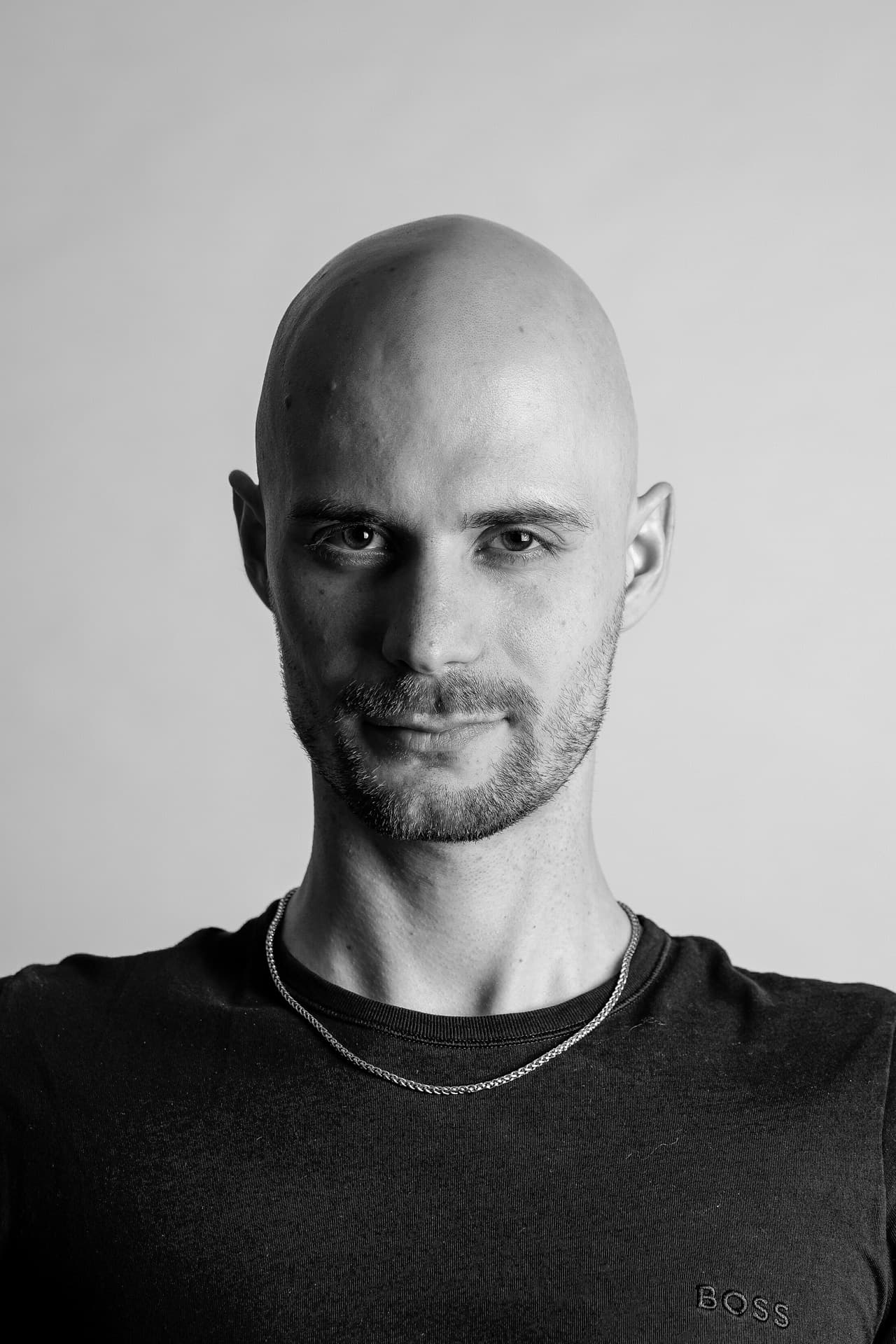 Black-and-white head-and-shoulders portrait of Andrei Potekhin against a light grey wall.